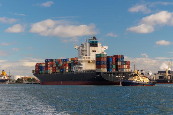 cargo ship on sea under blue sky during daytime